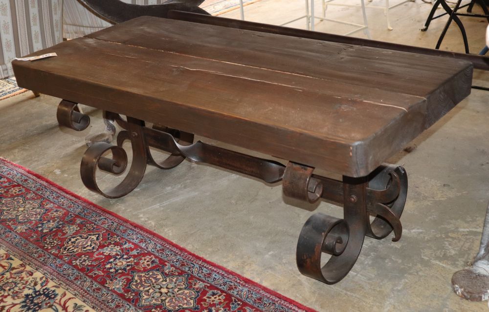 A wood and wrought iron coffee table, W.110cm, D.50cm, H.43cm